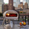 ROCCBOX Gozney Portable Outdoor Pizza Oven - Includes Professional Grade Peel, Built-In Thermometer and Safe Touch Silicone Jacket Propane Gas Fired, With Rolling Wood Flame Grey (RBX1GREYDE)